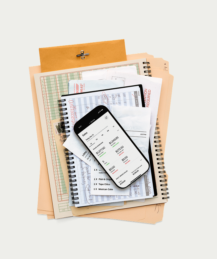 Square app on phone over messy ledgers and receipts — Sales overview for today; transition from paper to digital